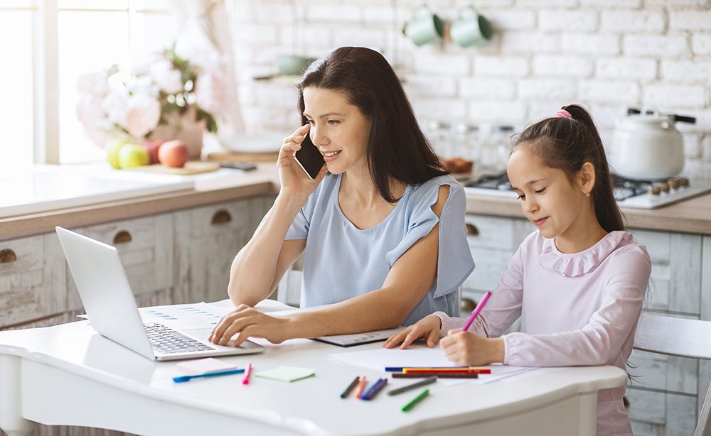 mother multitasking and working from home with her daughter