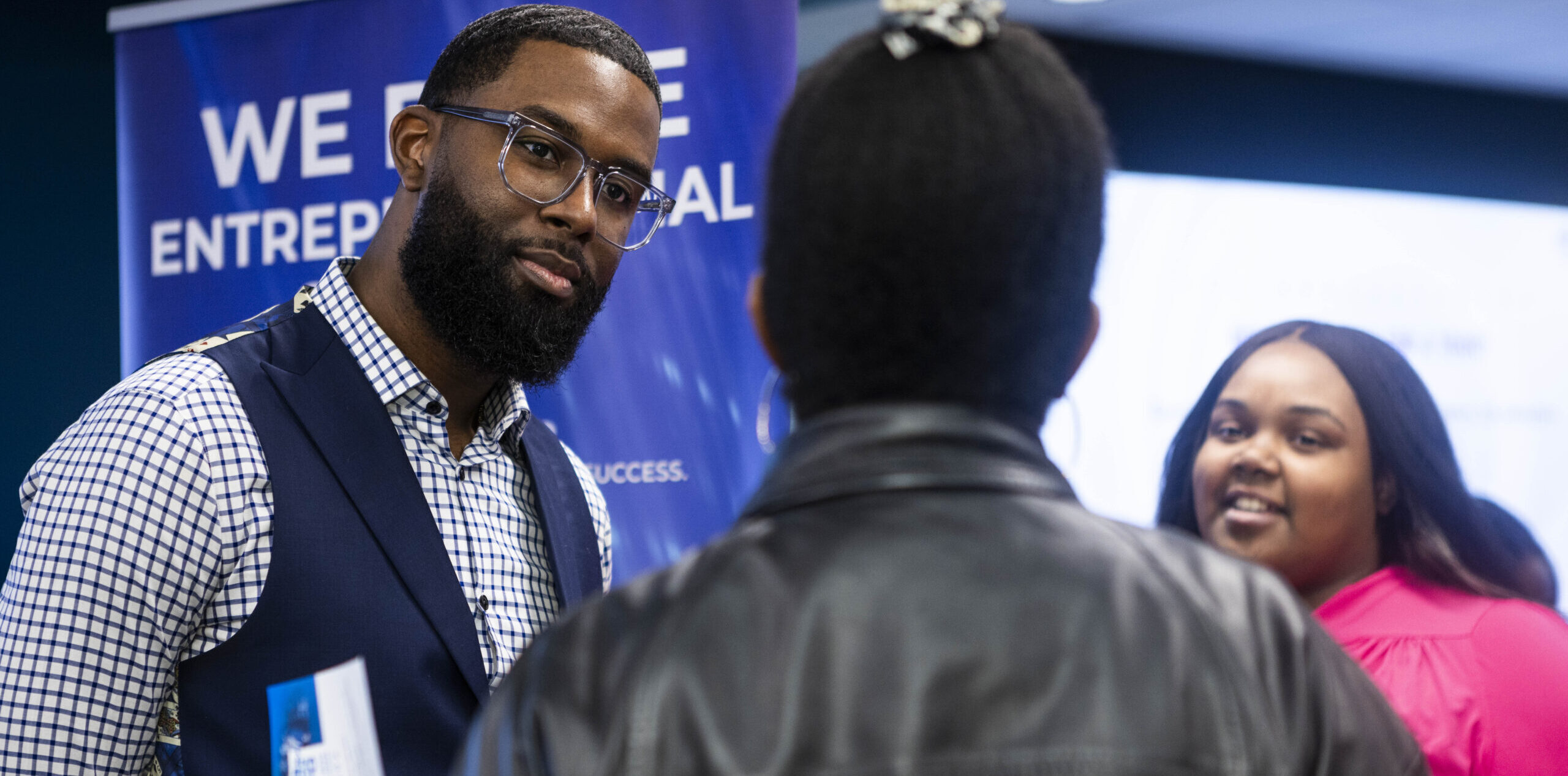 MIC team members talking at a resource expo