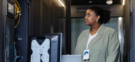 Waist up portrait of female IT engineer setting up server network, copy space